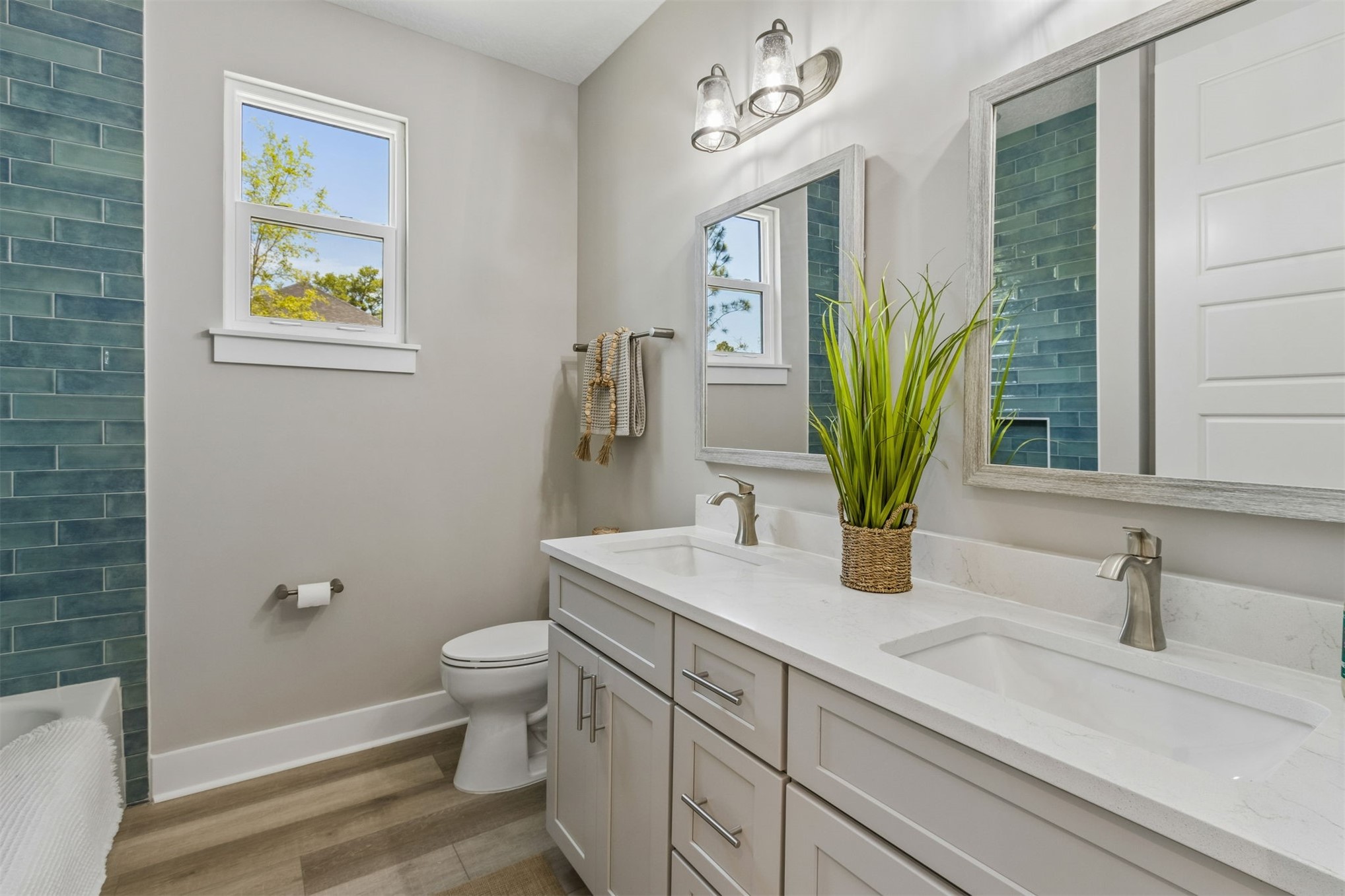 96050 Captains Pointe Road Yulee, FL 32097 - Photo 27 of 36 a bathroom with a sink a toilet and mirror