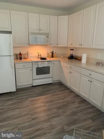 a kitchen with appliances cabinets and a counter top