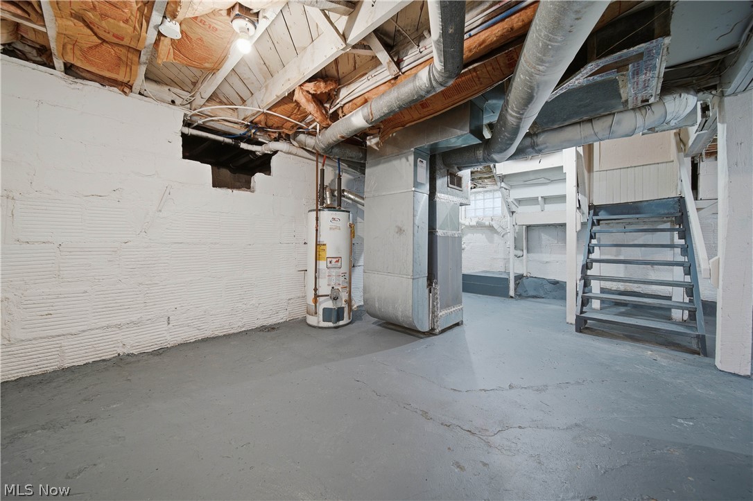 225 Cranz Place Akron, OH 44310 - Photo 27 of 34 Unfinished below grade area with stairs, heating unit, and water heater