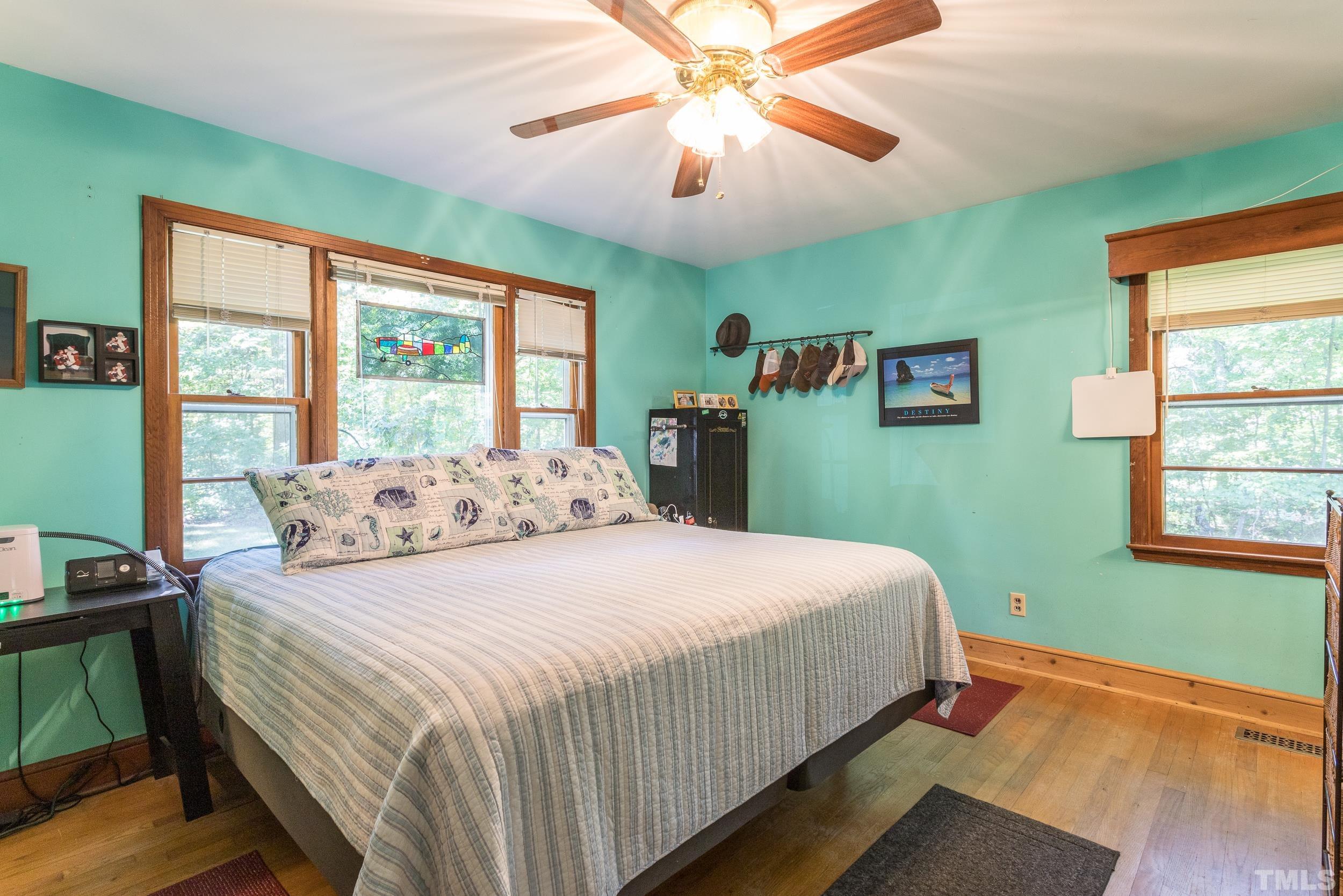 1708 Milton Road Durham, NC 27712 - Photo 22 of 27 a bedroom with a bed and a chandelier