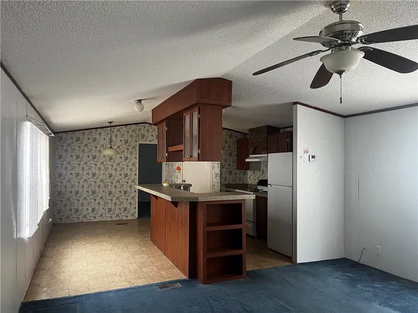 a kitchen with stainless steel appliances granite countertop a stove and a refrigerator