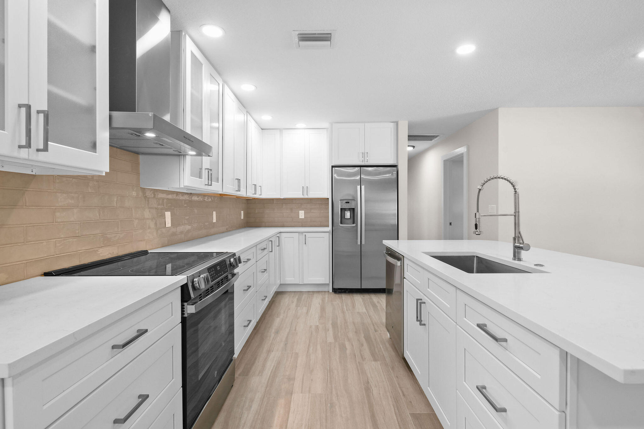 1522 Lance Road Jupiter, FL 33469 - Photo 13 of 50 a kitchen with a sink stove and refrigerator