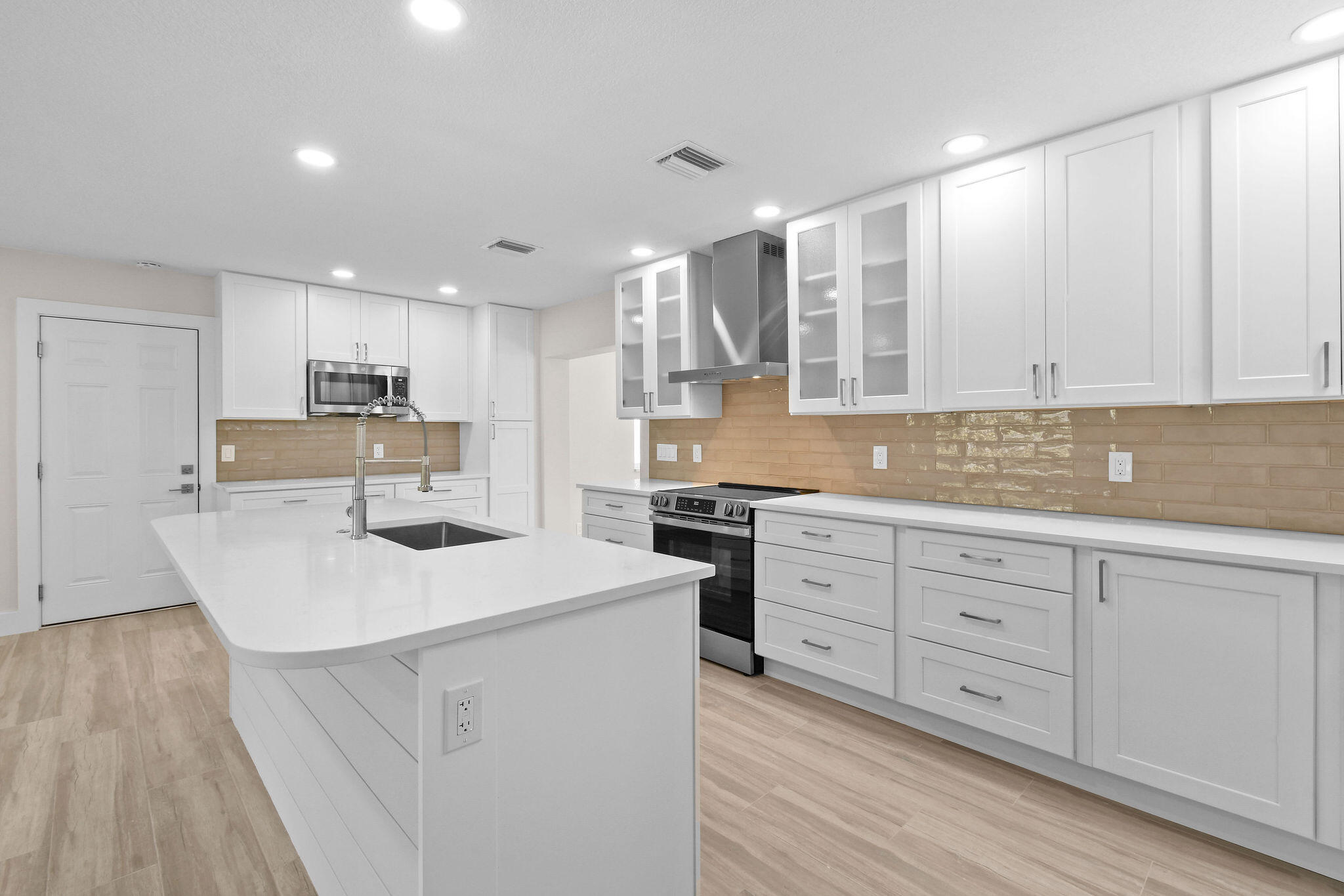 1522 Lance Road Jupiter, FL 33469 - Photo 14 of 50 a kitchen with white cabinets sink and white appliances