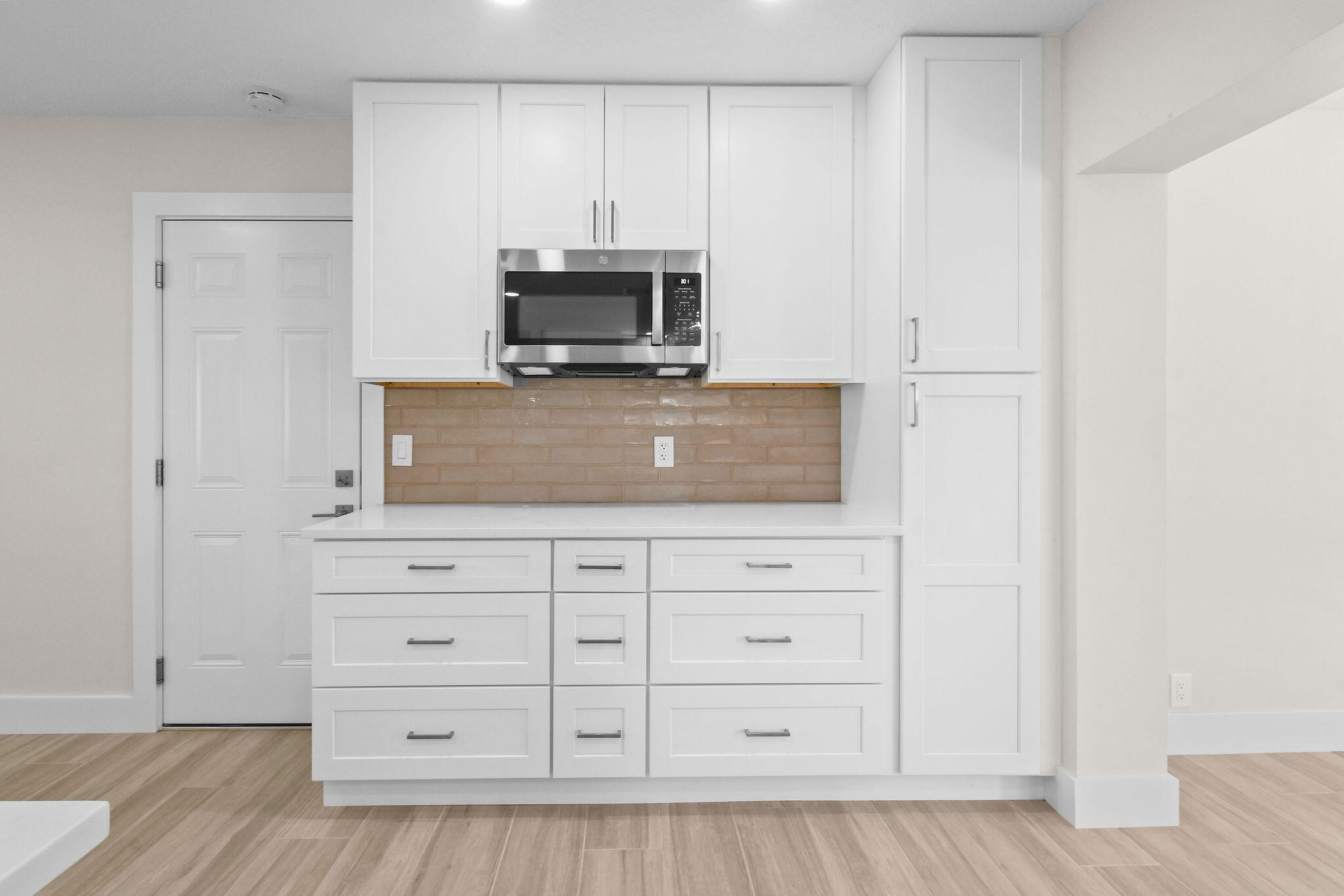 1522 Lance Road Jupiter, FL 33469 - Photo 15 of 50 a kitchen with white cabinets and appliances