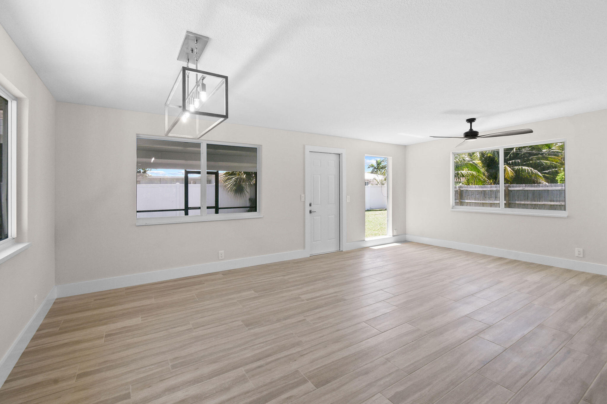 1522 Lance Road Jupiter, FL 33469 - Photo 16 of 50 a view of an empty room with wooden floor and a window