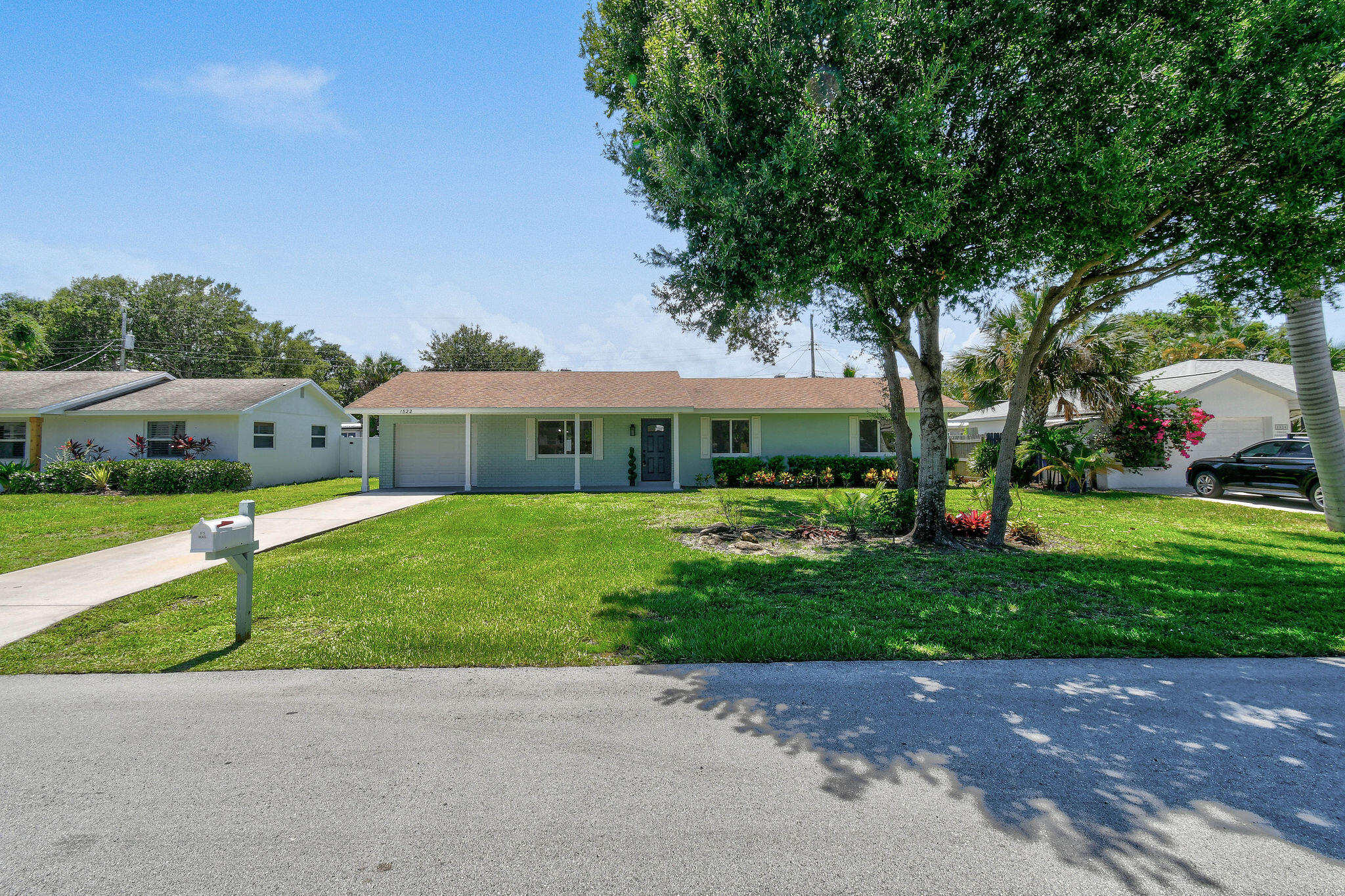 1522 Lance Road Jupiter, FL 33469 - Photo 2 of 50 a front view of house with yard and green space