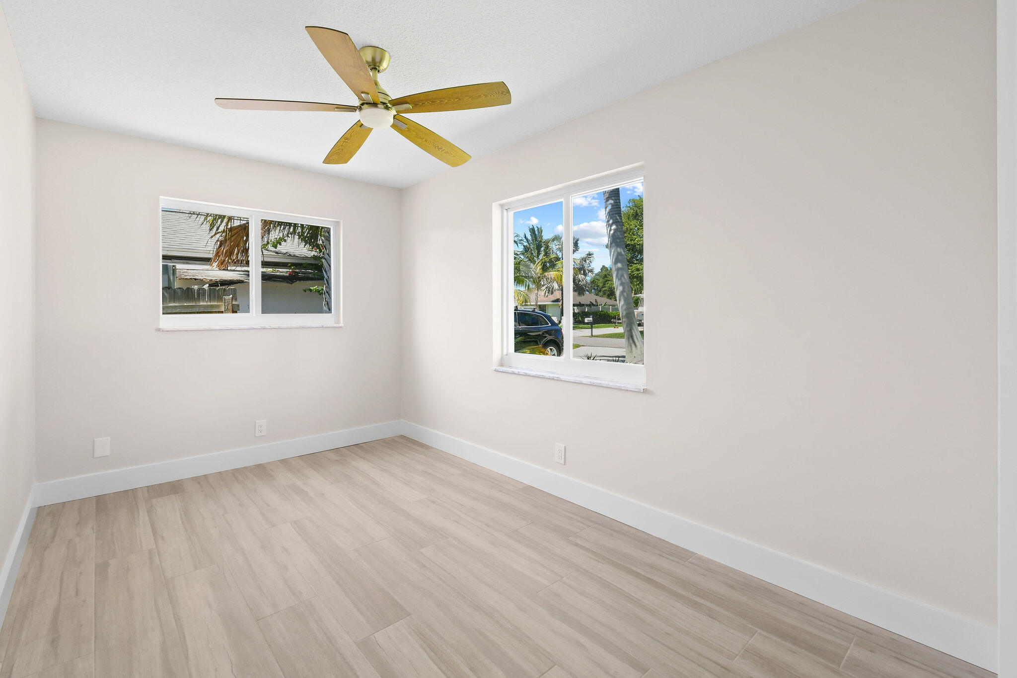 1522 Lance Road Jupiter, FL 33469 - Photo 26 of 50 an empty room with wooden floor and windows