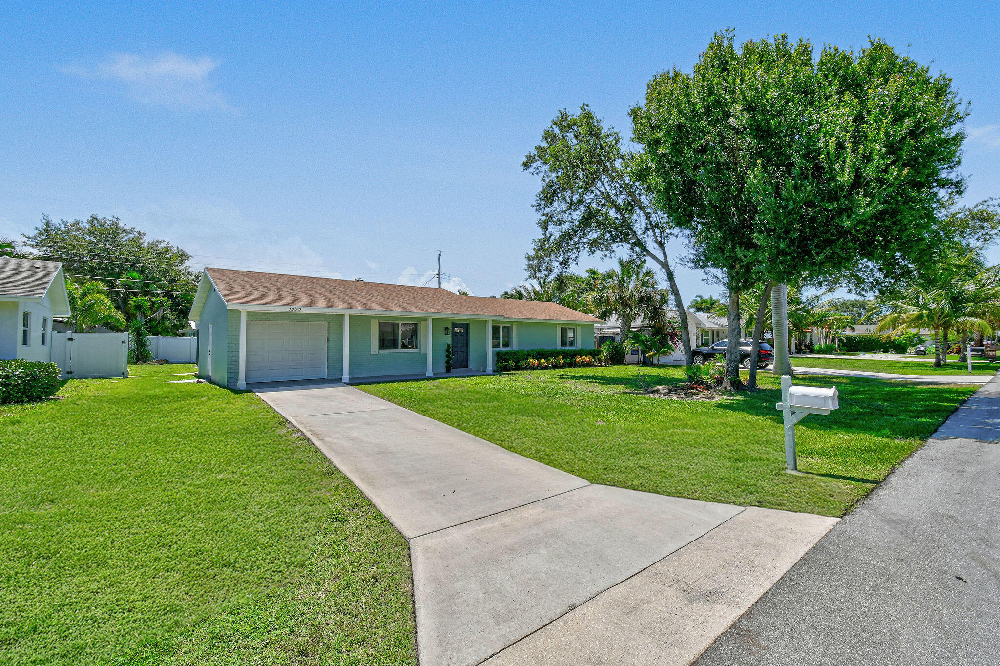 1522 Lance Road Jupiter, FL 33469 - Photo 3 of 50 a front view of a house with a yard