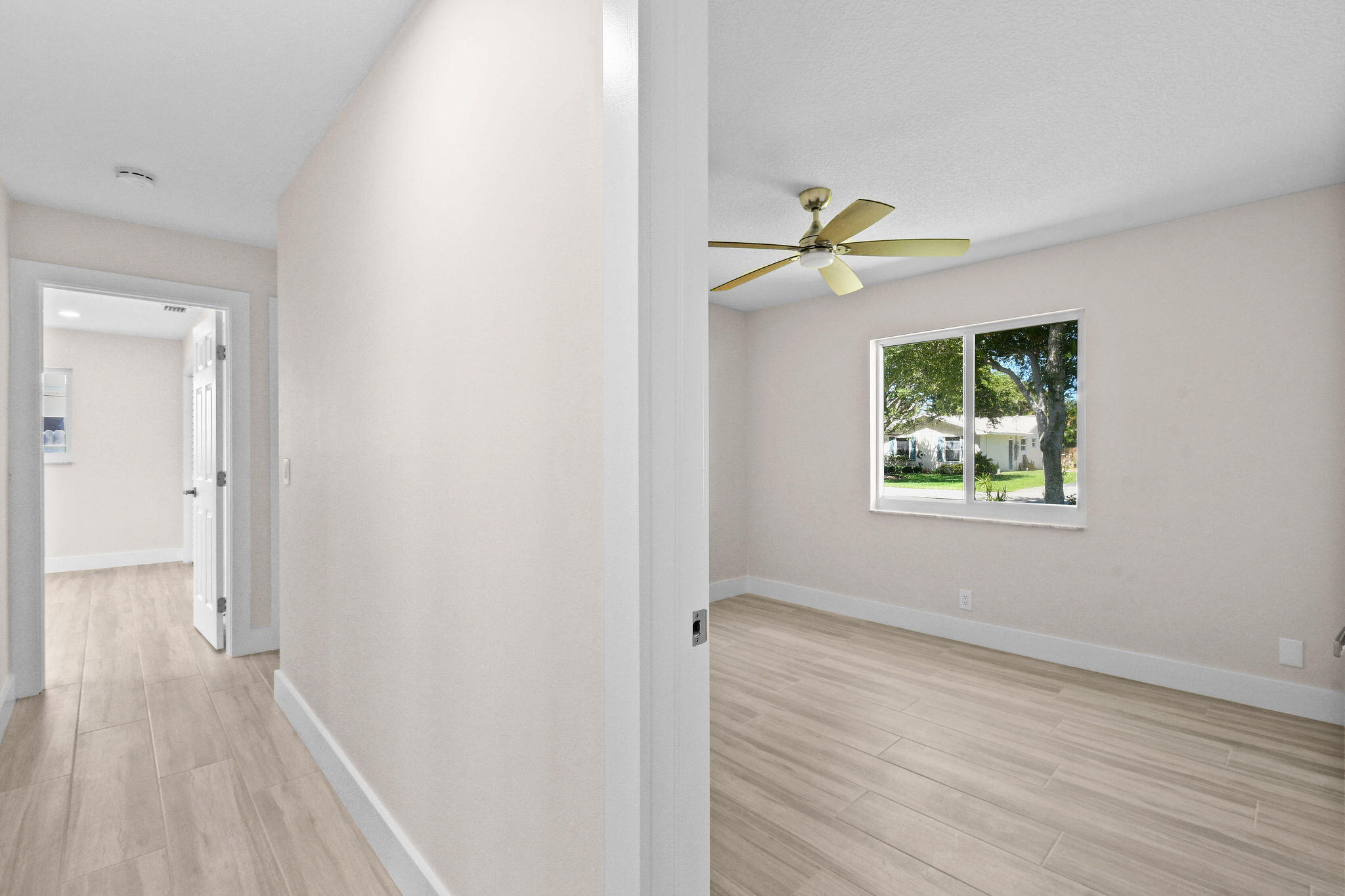 1522 Lance Road Jupiter, FL 33469 - Photo 31 of 50 a view of an empty room with a window and wooden floor