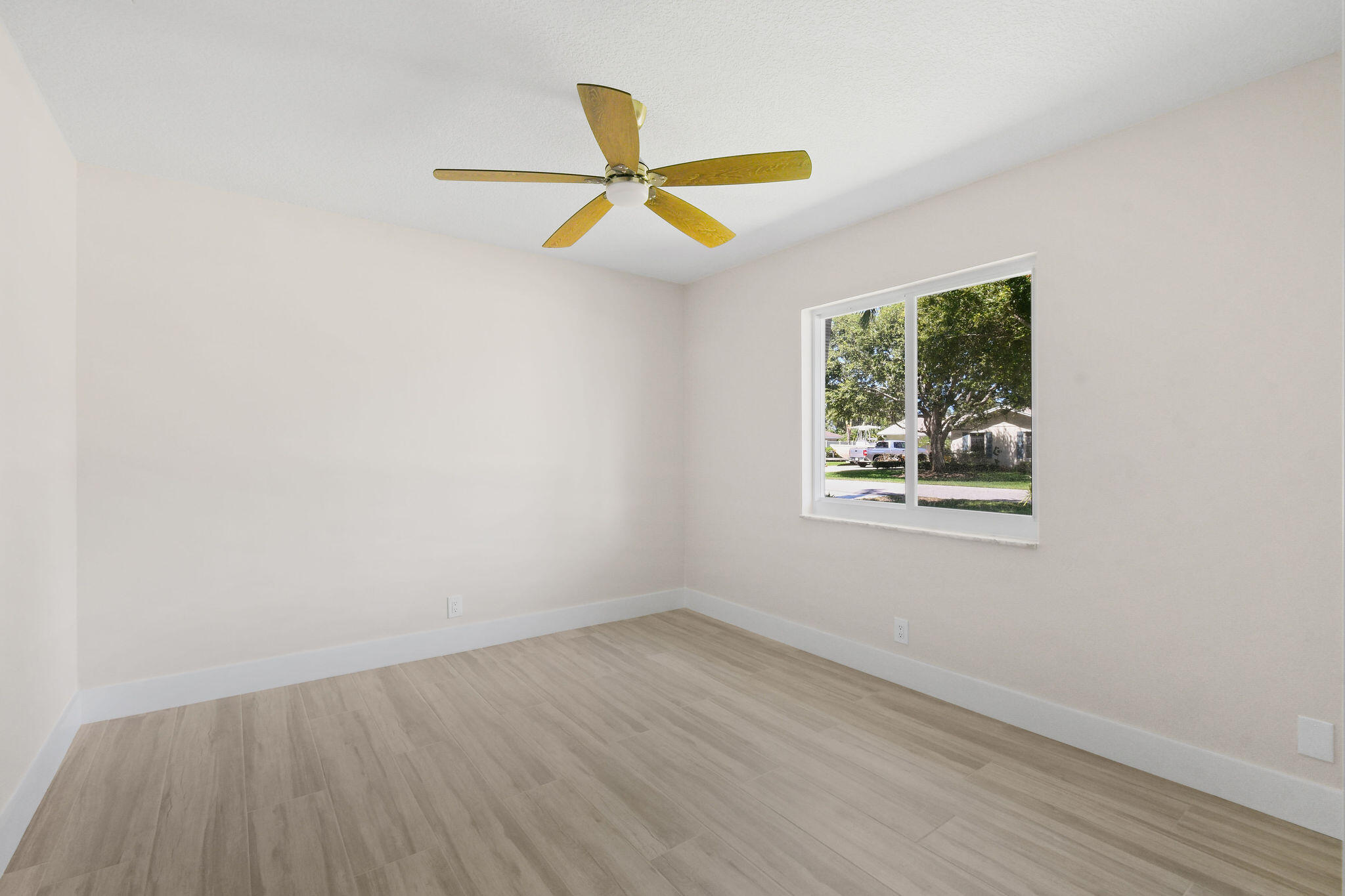1522 Lance Road Jupiter, FL 33469 - Photo 32 of 50 an empty room with wooden floor and windows
