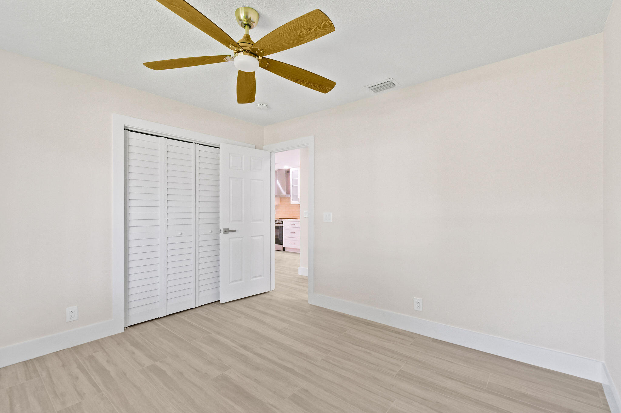 1522 Lance Road Jupiter, FL 33469 - Photo 34 of 50 an empty room with wooden floor and ceiling fan