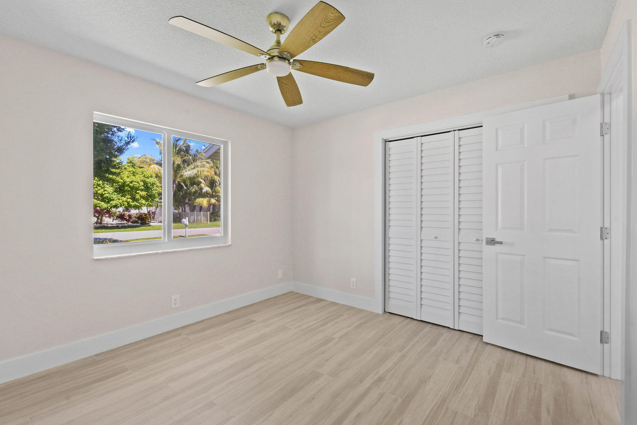 1522 Lance Road Jupiter, FL 33469 - Photo 35 of 50 wooden floor in an empty room with a window
