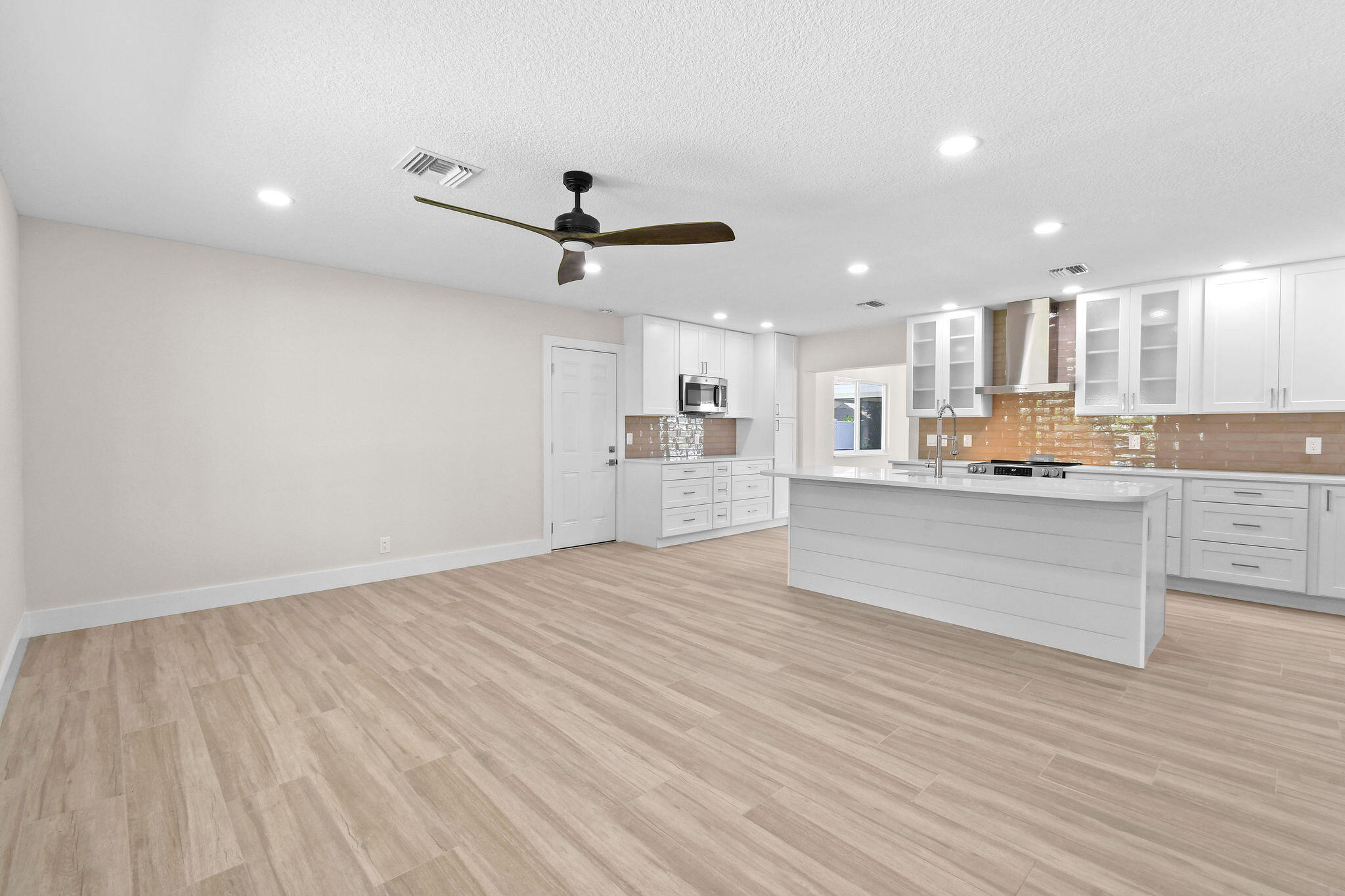 1522 Lance Road Jupiter, FL 33469 - Photo 6 of 50 a large kitchen with stainless steel appliances granite countertop a large counter top and a stove with wooden floor