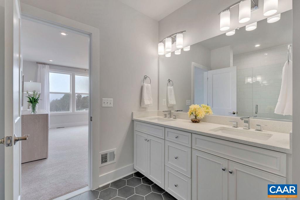 809 Wesley Lane, Unit A Charlottesville, VA 22911 - Photo 12 of 18 a bathroom with a double vanity sink and a mirror