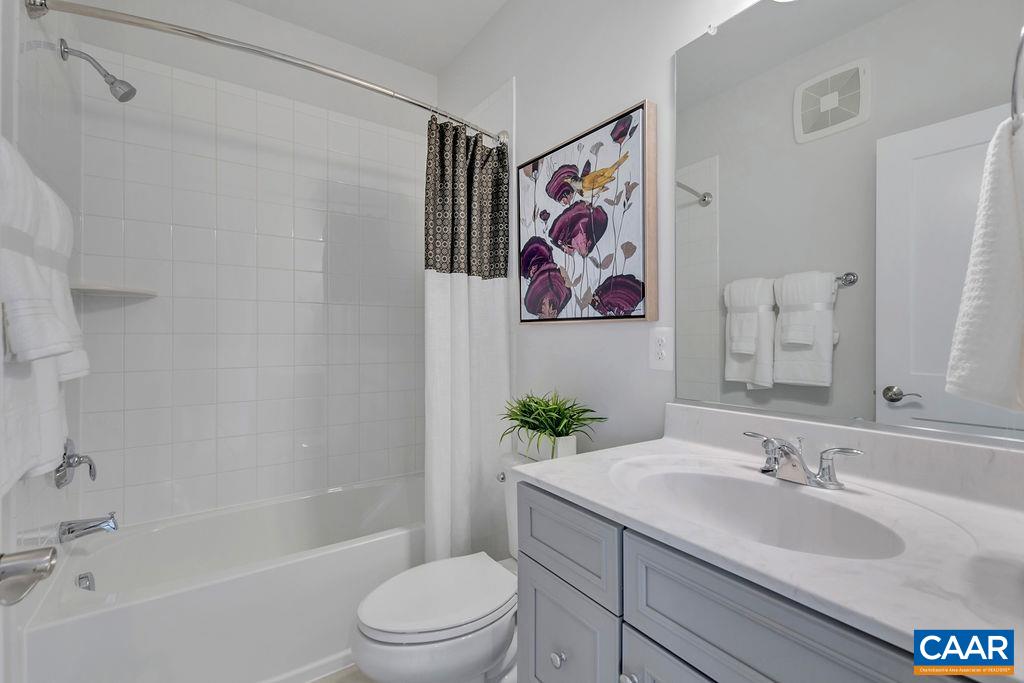 809 Wesley Lane, Unit A Charlottesville, VA 22911 - Photo 13 of 18 a bathroom with a granite countertop sink a toilet and a bathtub