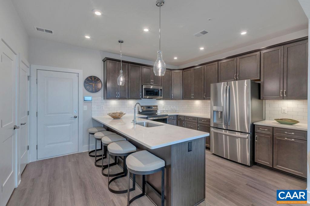 809 Wesley Lane, Unit A Charlottesville, VA 22911 - Photo 6 of 18 a kitchen with sink cabinets and stainless steel appliances