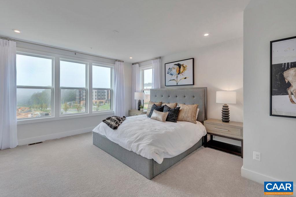 809 Wesley Lane, Unit A Charlottesville, VA 22911 - Photo 10 of 18 a spacious bedroom with a bed and a large window