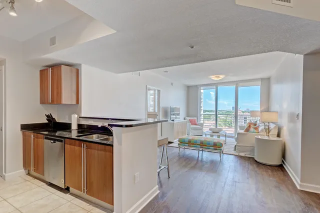 a kitchen with stainless steel appliances kitchen island granite countertop a stove a sink and a refrigerator