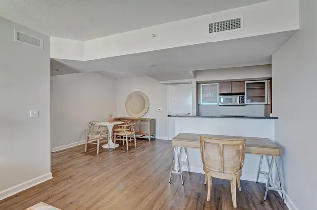 a view of a dining room with furniture and wooden floor