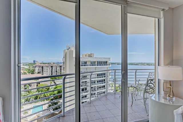 a view of a balcony with a chairs and table in the balcony