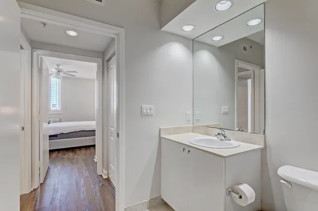 a en suite bathroom with a toilet a sink and mirror