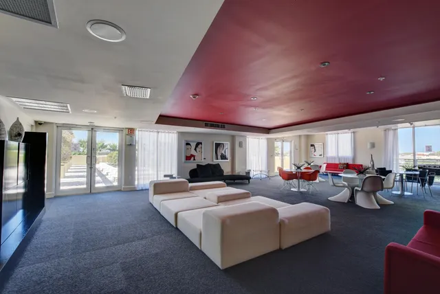 a living room with furniture fireplace and a large window