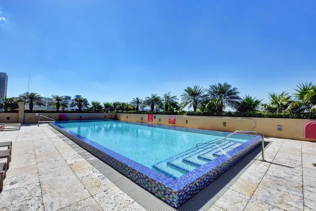 a view of a swimming pool with a yard