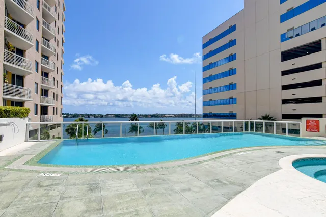 a view of pool with building and city view