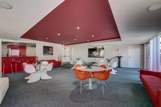 a living room with furniture a pool table and chairs