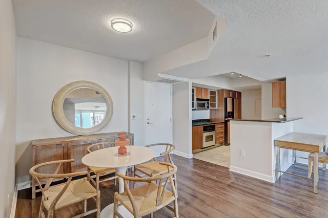 a living room with furniture a wooden floor and a bookshelf
