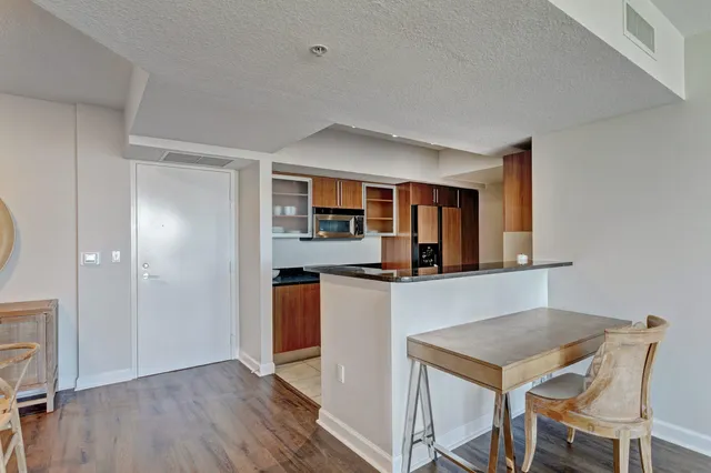 a kitchen with stainless steel appliances granite countertop a stove and a refrigerator