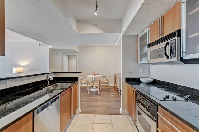 a kitchen with granite countertop a stove and cabinets