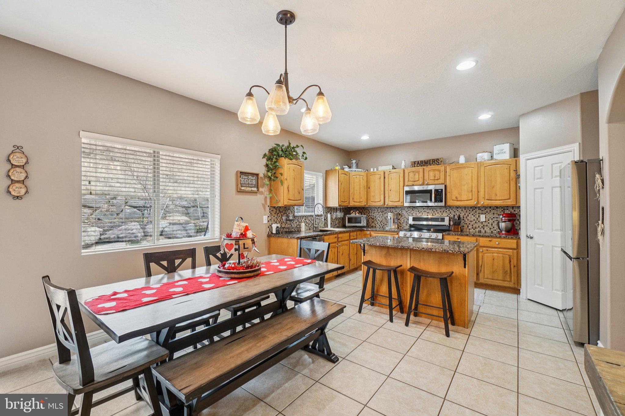 1340 South Orchard Road Vineland, NJ 08360 - Photo 20 of 42 a dining room with stainless steel appliances granite countertop a rug a kitchen island and chairs