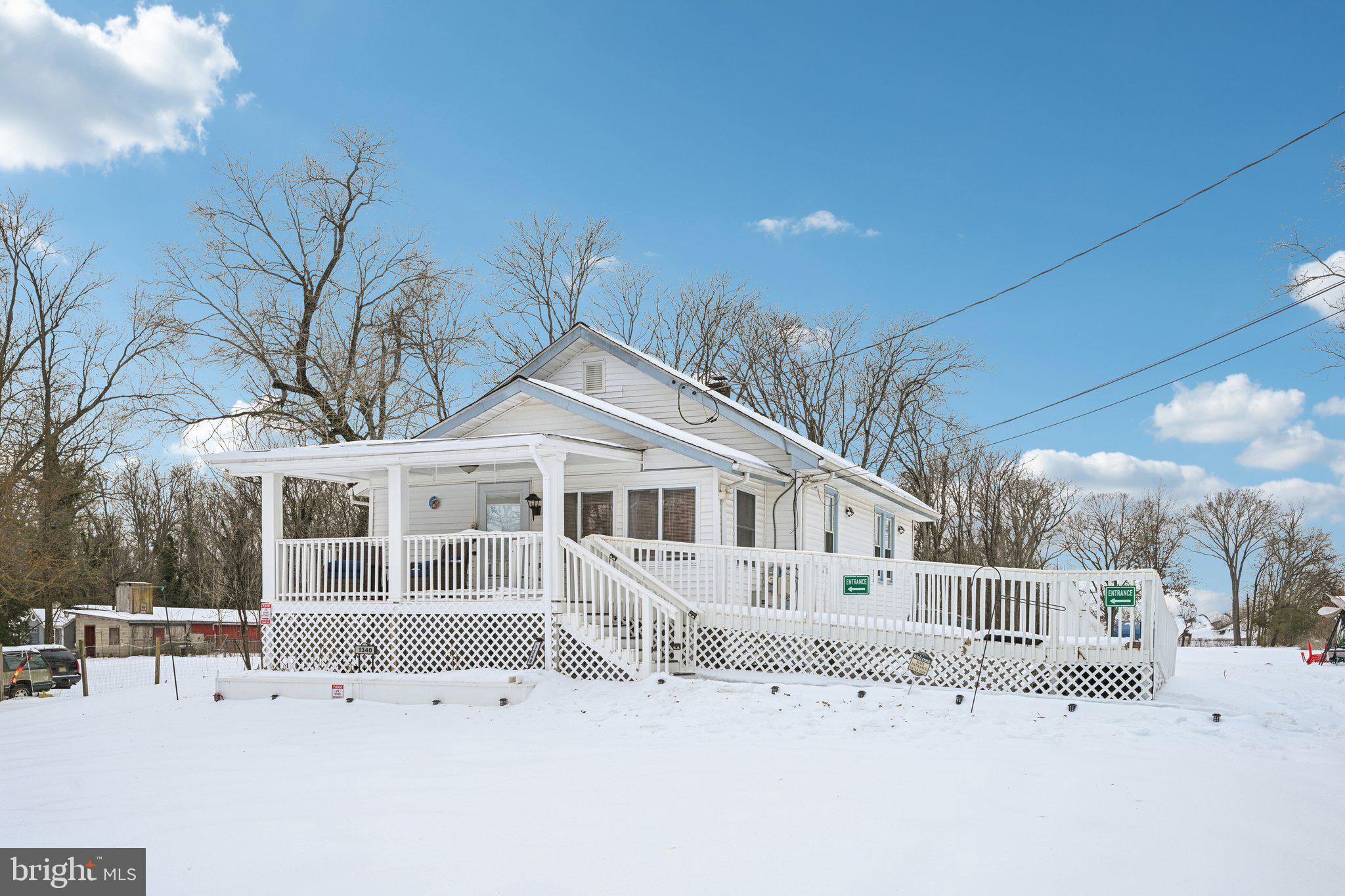 1340 South Orchard Road Vineland, NJ 08360 - Photo 2 of 42 a view of a white house with a yard covered in snow