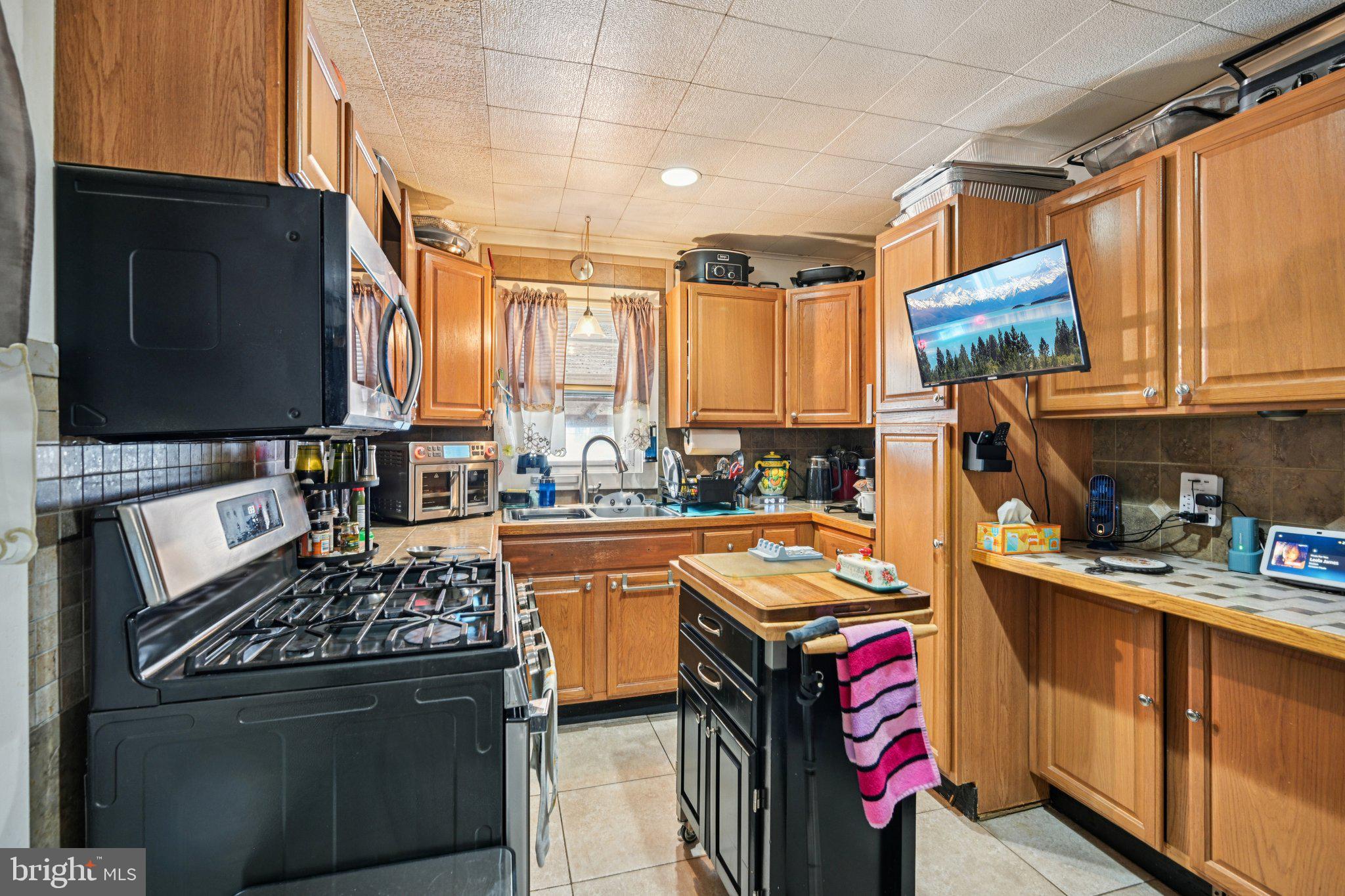 1340 South Orchard Road Vineland, NJ 08360 - Photo 21 of 42 a kitchen with stainless steel appliances granite countertop a stove top oven a sink dishwasher and cabinets with wooden floor