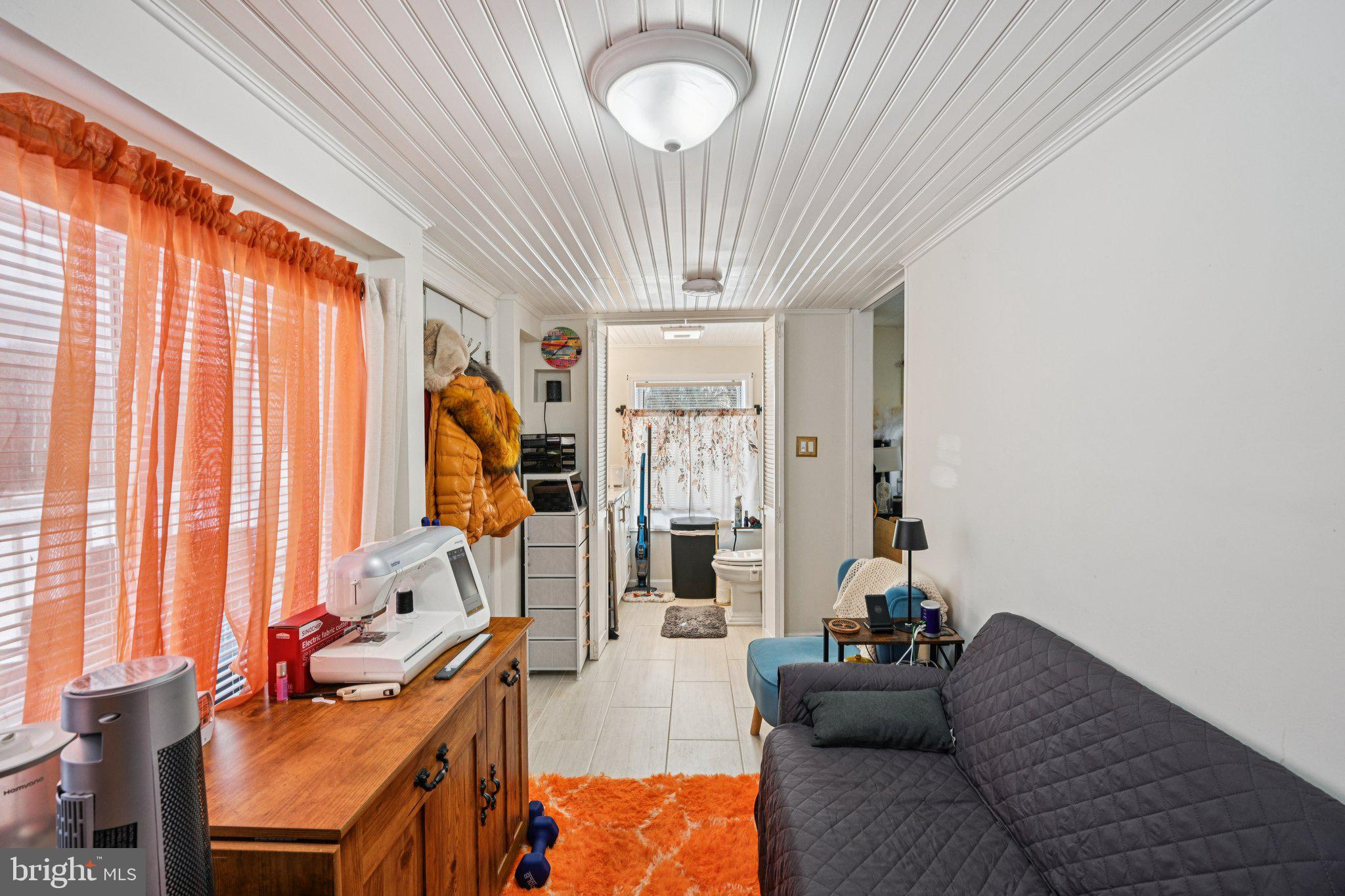 1340 South Orchard Road Vineland, NJ 08360 - Photo 31 of 42 a living room with furniture a chandelier and a window