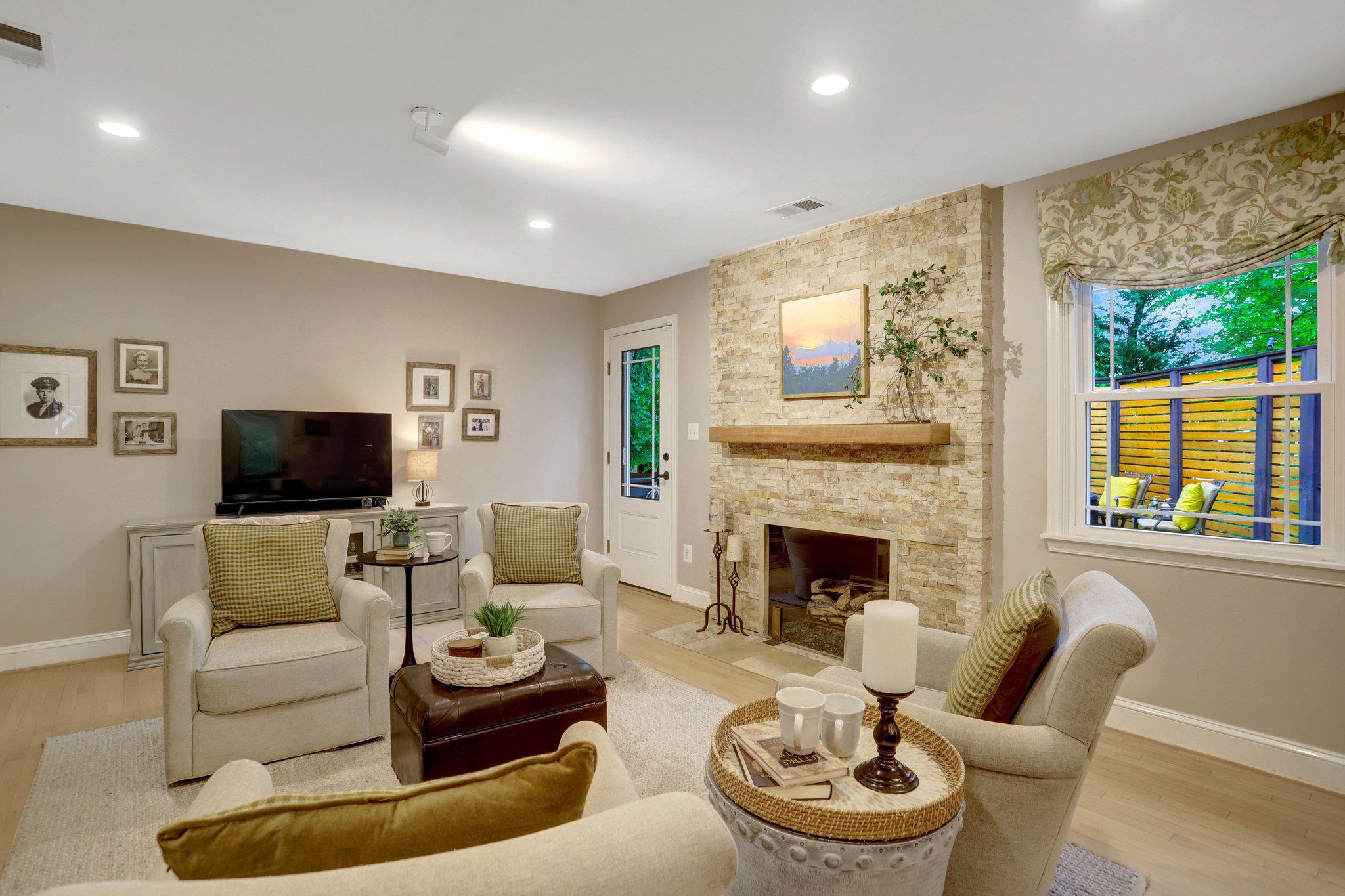 7506 Oriole Avenue Springfield, VA 22150 - Photo 11 of 67 a living room with furniture a fireplace and a flat screen tv