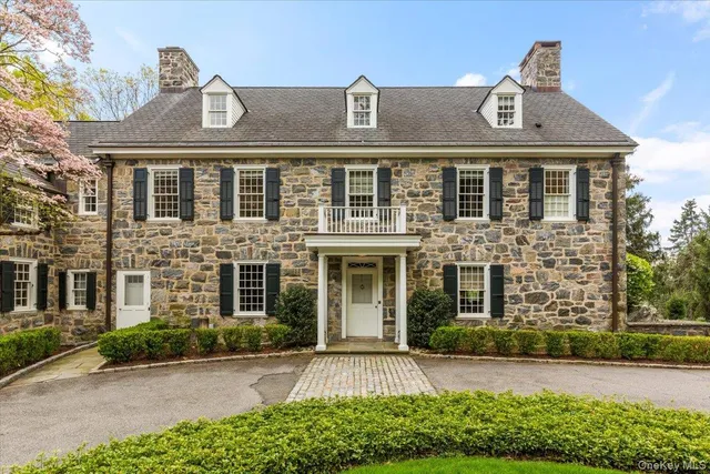 front view of a brick house with a yard
