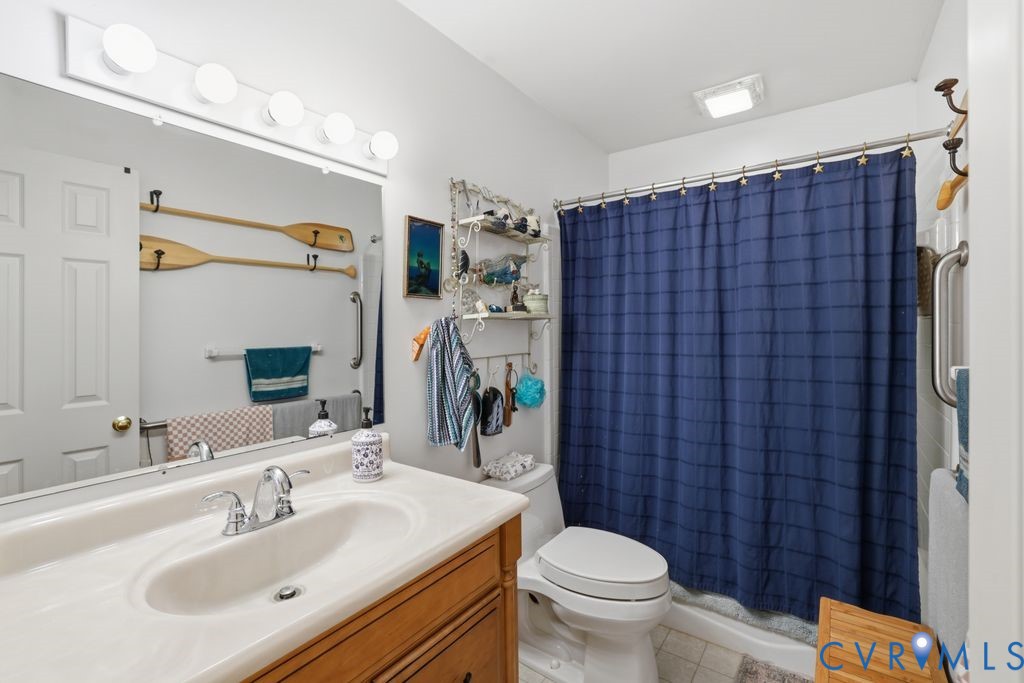 1061 Turkey Ridge Drive Moseley, VA 23120 - Photo 24 of 51 a bathroom with a sink a toilet and shower curtain