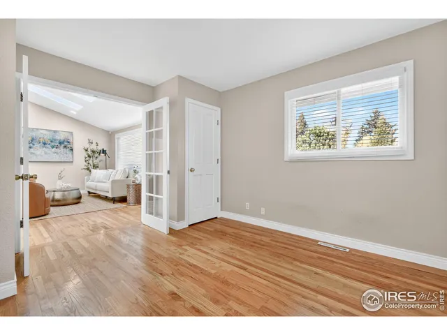 a view of an empty room and wooden floor