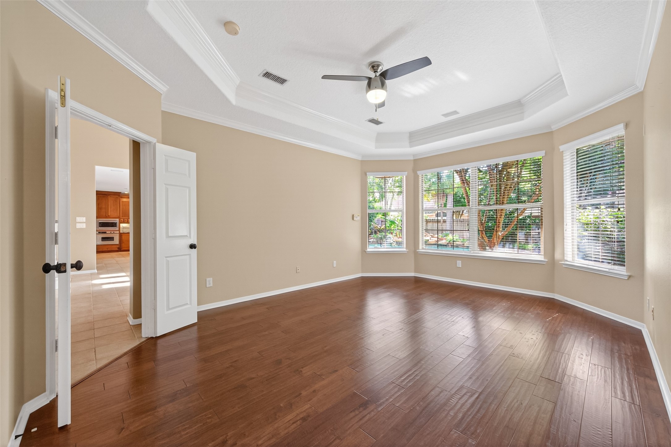 10 Mirror Ridge Drive The Woodlands, TX 77382 - Photo 21 of 48 Overlooking the backyard, the primary bedroom showcases beautiful bay-style windows that enhance openness and bring in abundant natural light