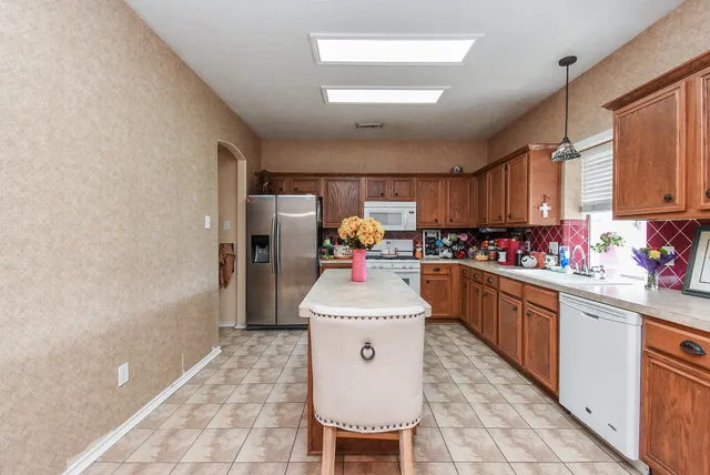 a kitchen with a sink cabinets and window