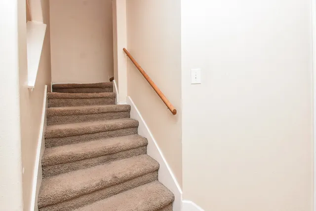 a view of staircase with white walls