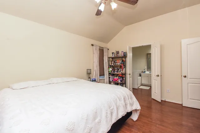 a spacious bedroom with a bed and a closet