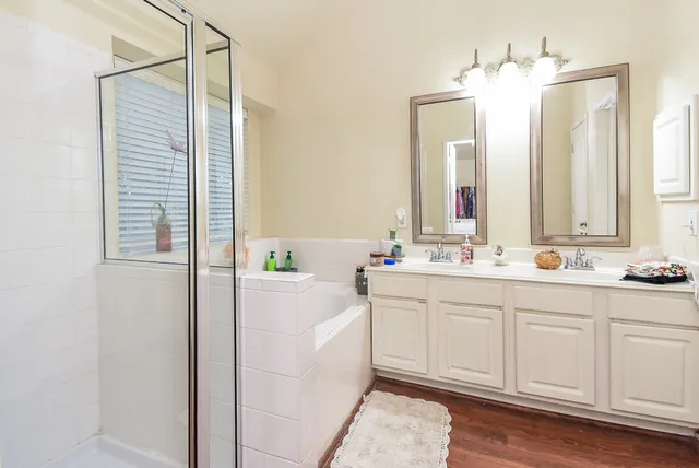 a bathroom with a double vanity sink mirror and