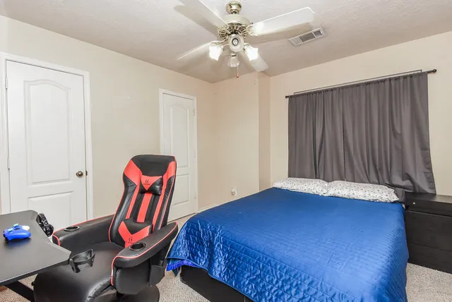 a bedroom with furniture and wooden floor