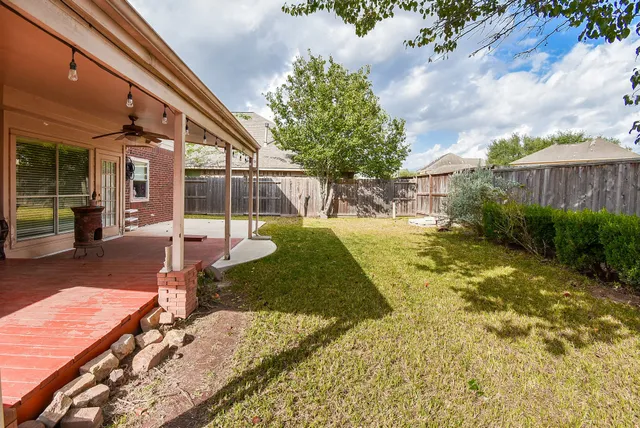 a view of a backyard with sitting area
