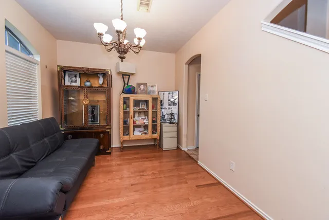 a living room with furniture and chandelier