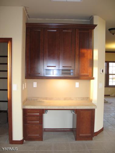 8990 Coolidge Road, Unit 7 Yakima, WA 98903 - Photo 6 of 15 a view of kitchen with wooden cabinets and a stove top oven