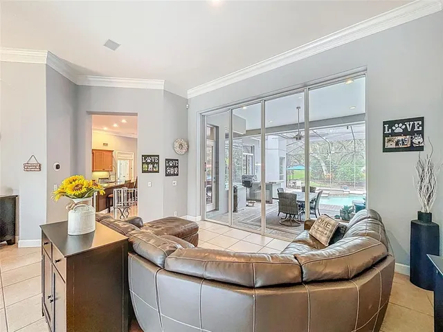 a kitchen with a dining table chairs and large window